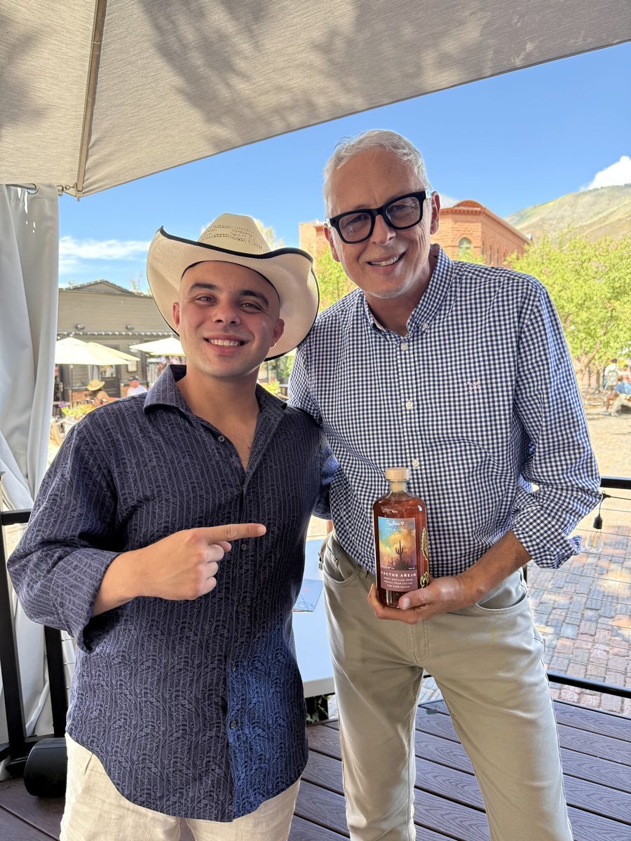 Simon Bull holding a bottle of Cactus Añejo beside Paul Montiel, founder of Aspen Privé, on the Bosq patio