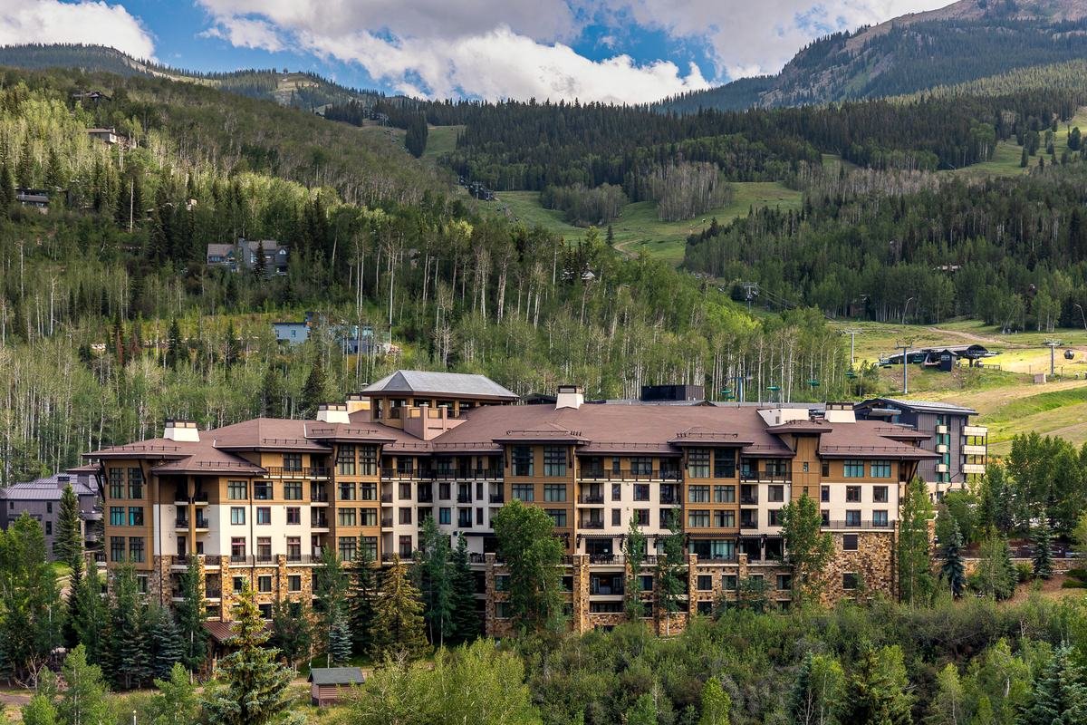 Viceroy Snowmass seen from across the valley in summer, set below the ski runs and chairlifts of Snowmass Mountain