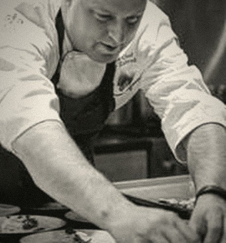 Matt Zubrod plating dishes in a kitchen