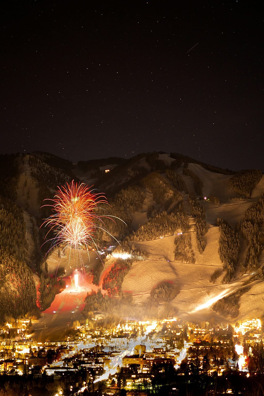 Fireworks over Aspen Mountain above the town lights