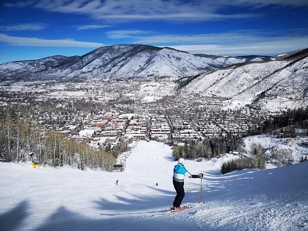 A skier above the town of Aspen on a clear winter morning