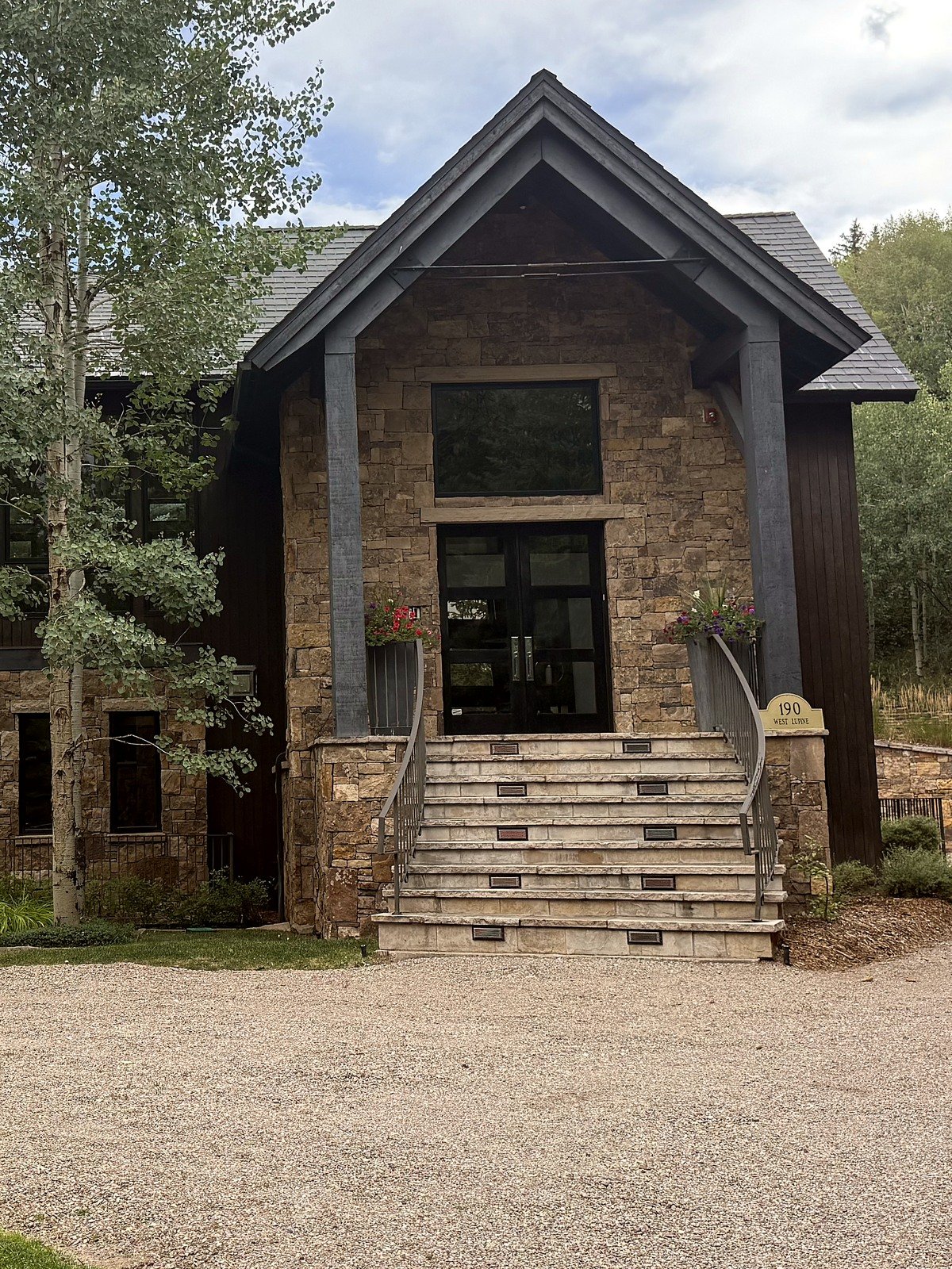 The entrance to 190 W Lupine Drive from the drive, with the address marker beside the steps