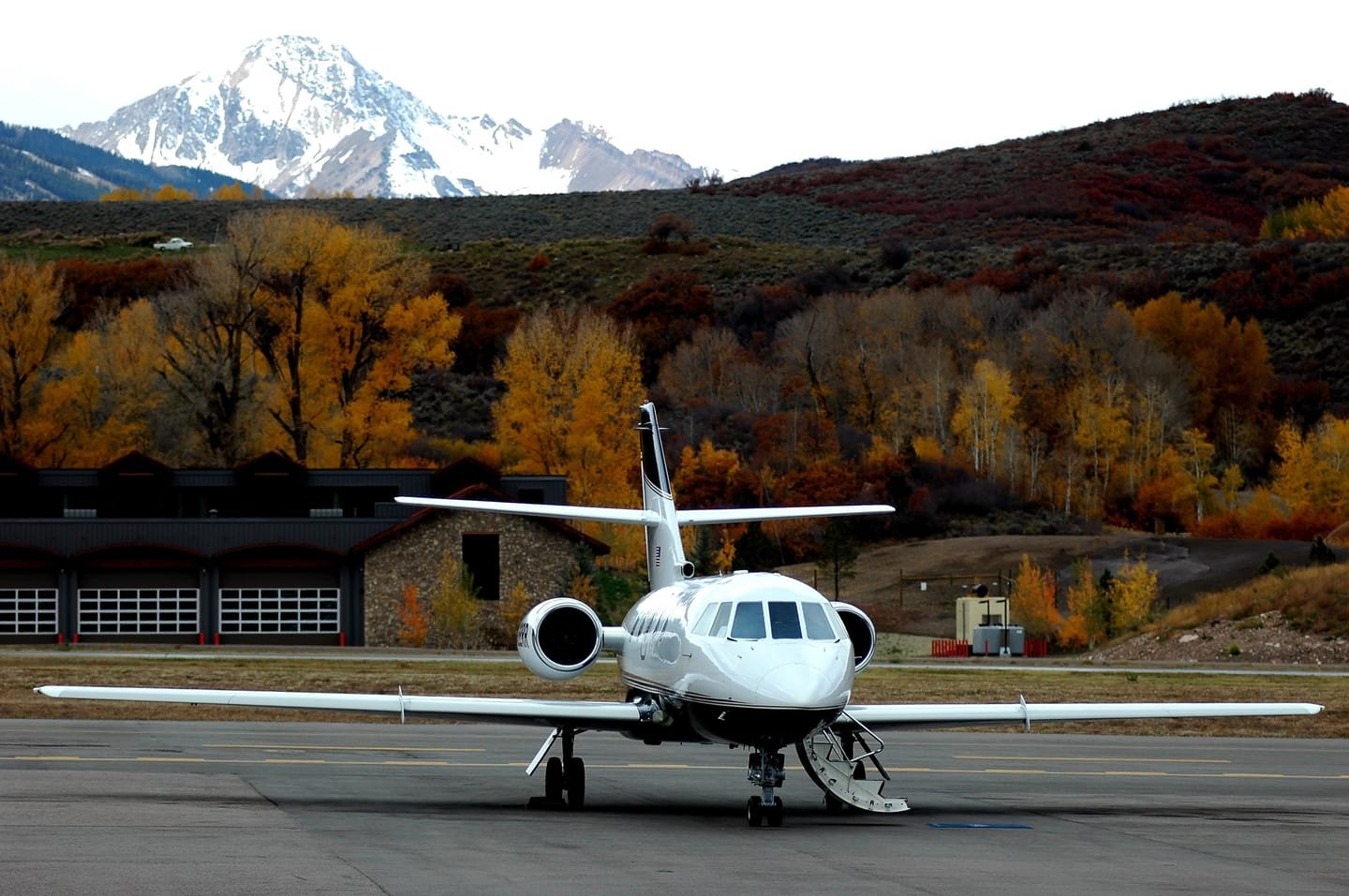 A private jet on a mountain airport ramp in autumn