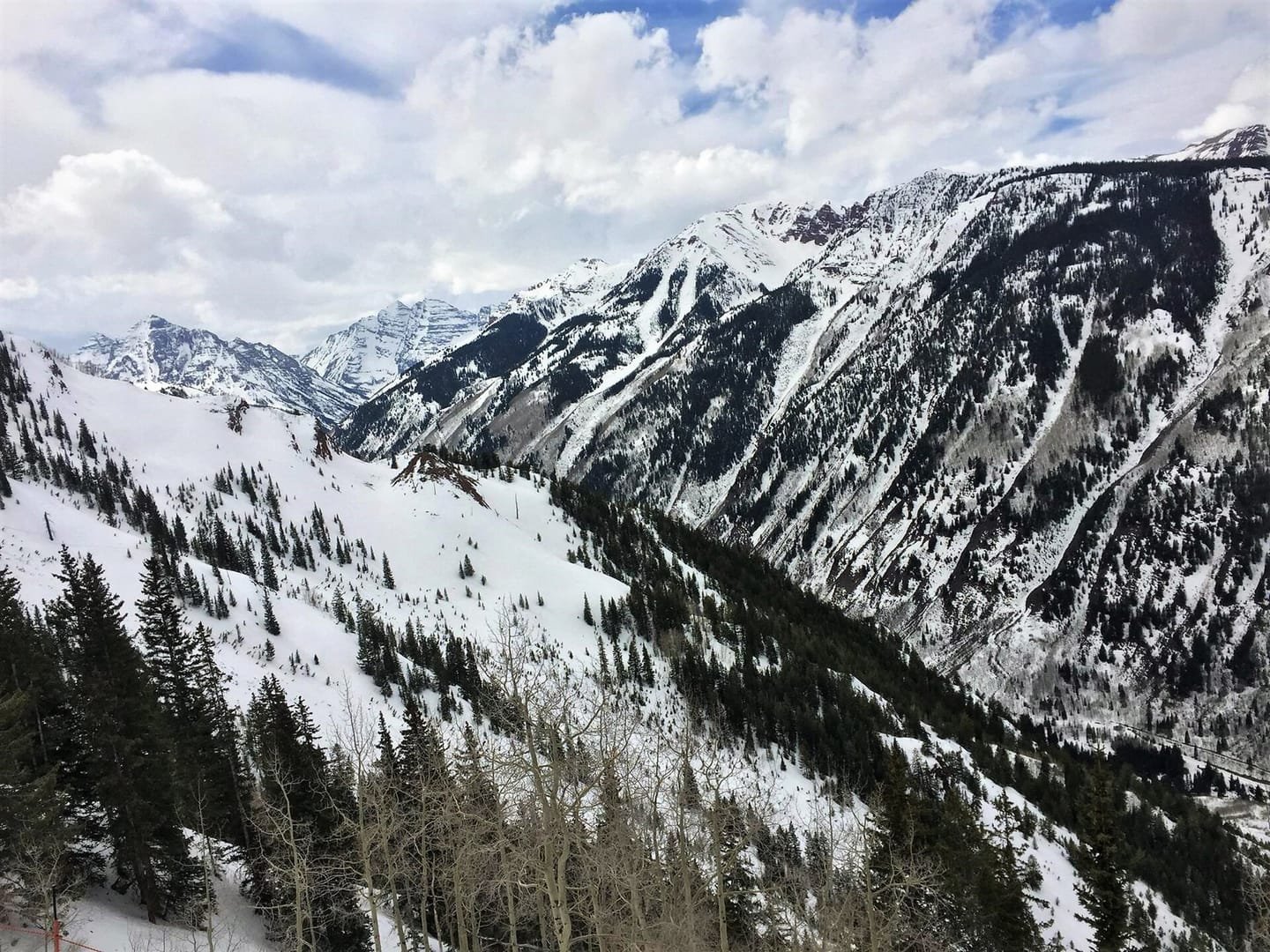 Snow-covered forest below the Maroon Bells in winter