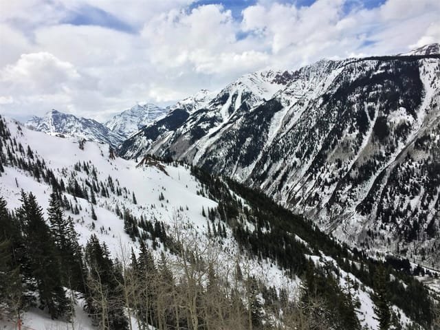 Snow-covered forest below the Maroon Bells in winter