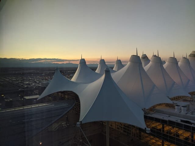 Denver International Airport's main terminal at dusk