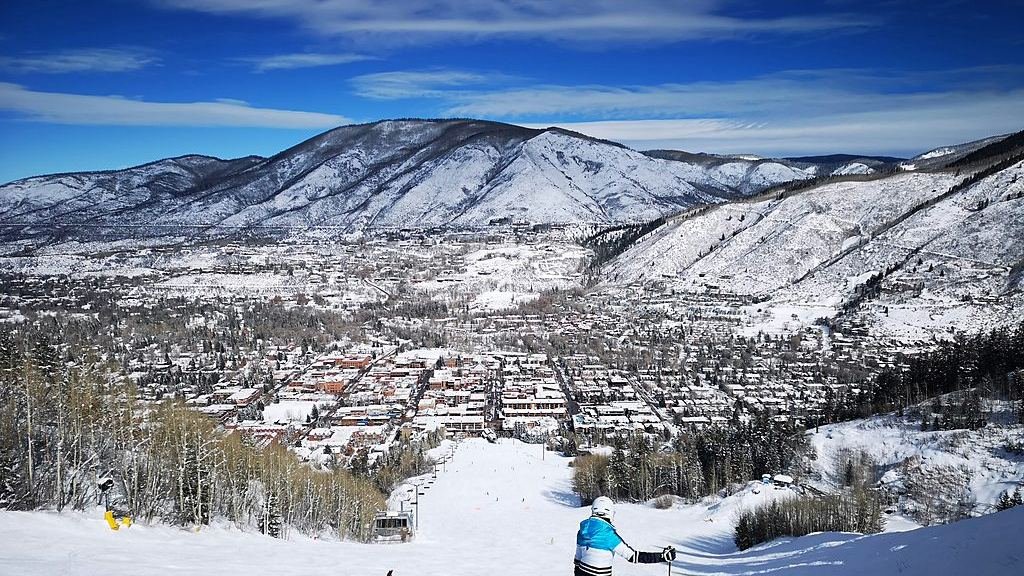 A skier on a groomed run on Aspen Mountain above town