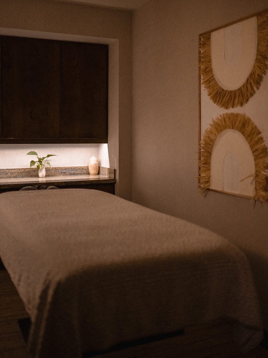 Quiet spa treatment room prepared for an in-residence session